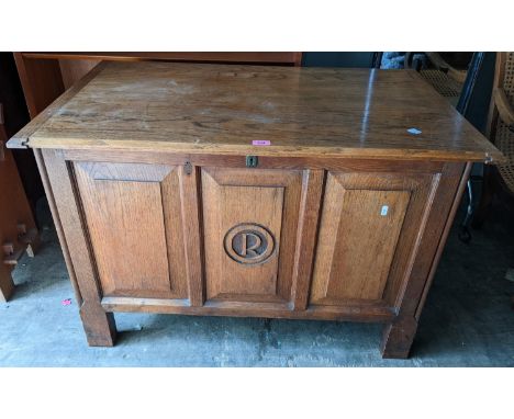 A coffer having a hinged top and the panelled front carved with the initial R, 69h x 103w, Location: 