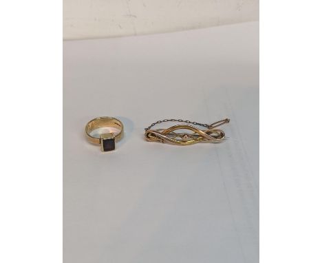 A gold coloured crossover brooch, and a 9ct gold ring set with a garnet 6.75g Location: 