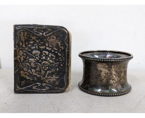A silver napkin ring and a prayer book decorated with cherubsLocation: 