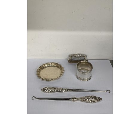 Two silver handled button hooks marked Birmingham 1903, together with a napkin ring and coaster, total weight, 122.4g, Locati