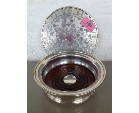 A silver wine coaster with wooden base, together with a white metal and glass table stand 15cm diameter Location: R1.3 