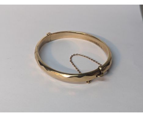 A 9ct gold bangle A/F, with safety chain, 9.4gLocation: 