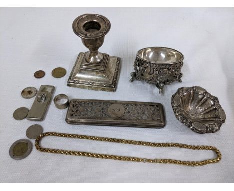 A mixed lot to include a silver weighted candlestick, silver dressing table lid, cigar cutter, gold plated chain and other it