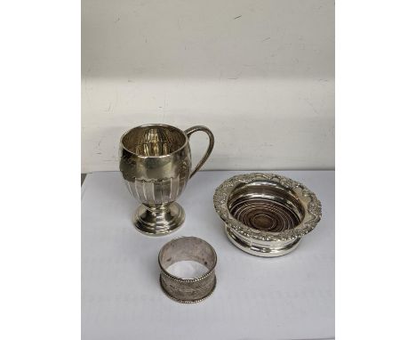 An early 20th century silver Christening cup engraved Hugh Gerald Digby 19.8.28, together with silver bottle coaster, hallmar