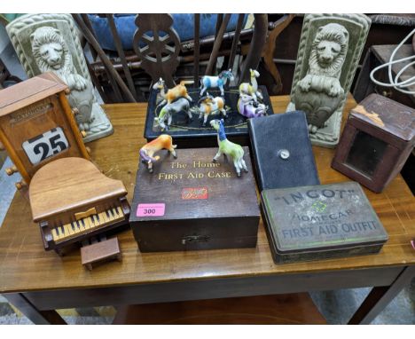 A mixed lot to include a pair of composition heraldic lion bookends, First Aid kits, a world atlas and gazetteer book with in