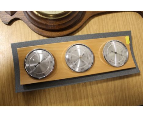 A VINTAGE OAK WALL BAROMETER WITH SWIRLED THERMOMETER TOGETHER WITH A MODERN EXAMPLE (2)
