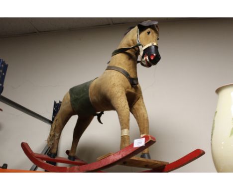 A VINTAGE STRAW FILLED WOODEN ROCKING HORSE 