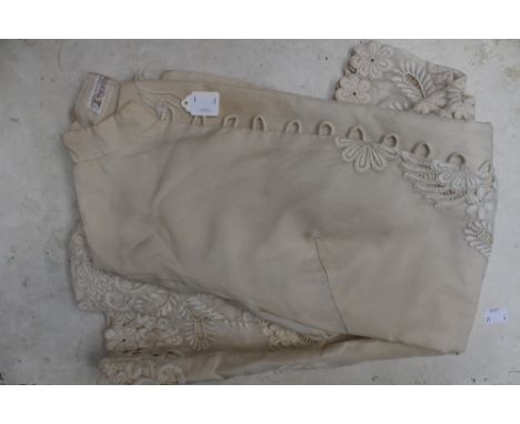 A cream georgette ladies' jacket, having raised embroidered panels to the front and sleeves, being lined in cream cotton, mad