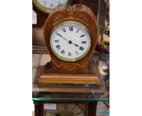 A mahogany heart shaped mantel clock, marquetry inlay, white enamel dial, Roman numerals, tiered plinth base 