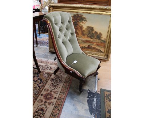 A mid Victorian walnut spoon back nursing chair, having a deep buttoned back, sprung upholstered seat and raised on French ca