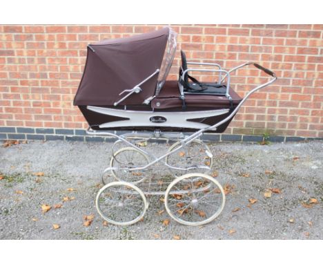 A 'Silver Cross' pram, extra child's seat and shopping basket below