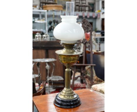 A late 19th Century brass oil lamp, complete with glass runner, made by Youngs De-Lite, incandescent, 48 cm high, complete wi