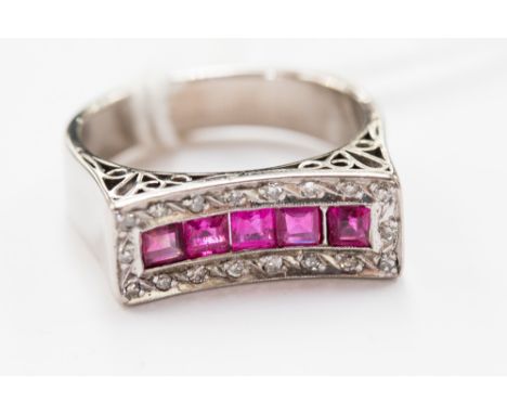 A ruby and diamond ring, having central row of five calibre cut rubies within rectangular diamond set mount, white metal, unm