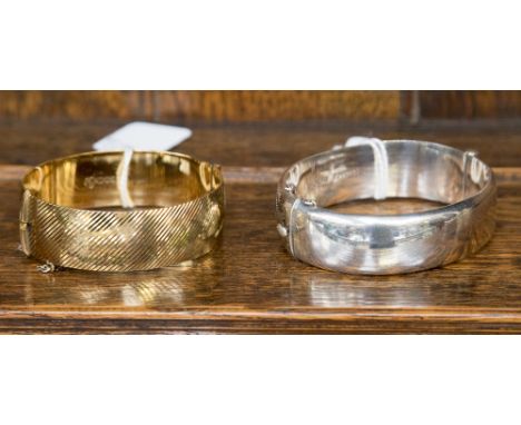A vintage silver-gilt bangle marked 22 ct on silver with safety chain and angled line decoration, marked 'FM', possibly F. Ma
