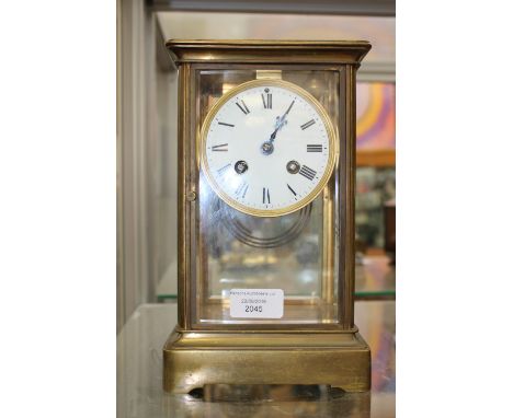A French brass mantel clock, with a white enamelled dial, black Roman numerals, twin winding holes, the movement signed 'Mari