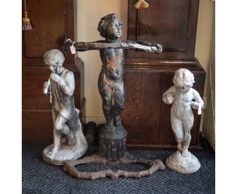 Two reproduction concrete garden statues and a cast iron cherub stick stand (3)