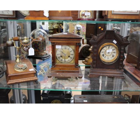 An Ansonia carved oak mantel clock, a German mantel clock and a mahogany telephone (3)