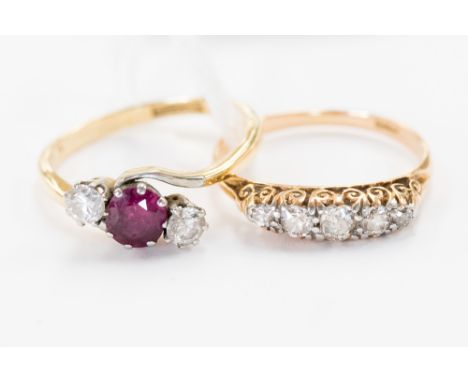 An 18 ct gold ring set with five diamonds, with an 18 ct gold ring set in platinum, with one ruby and two diamonds (2) 