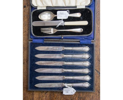 A cased set of six silver dessert knives, Sheffield 1978, with a cased silver dessert spoon and fork Sheffield 1938 and Sheff