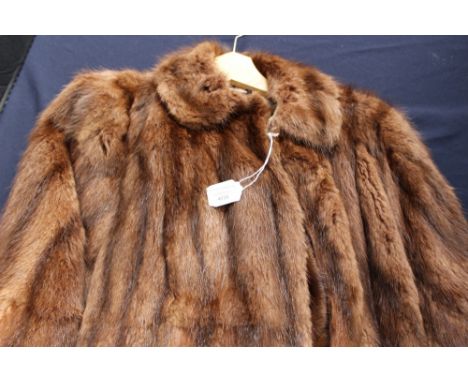 A vintage mink shrug with pockets together with a musquash jacket 