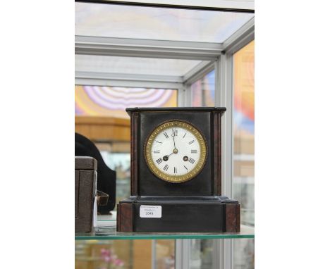 A granite mantel clock, with dark brown marble columns, Roman numerals, stamped manufacturer to workings C.J. & Co (key)