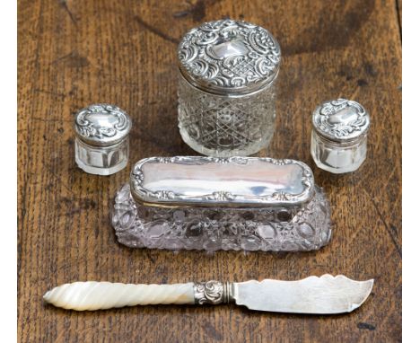 A silver topped and cut glass dressing table set, Birmingham 1924, with a silver knife having mother-of-pearl wrythen handle 