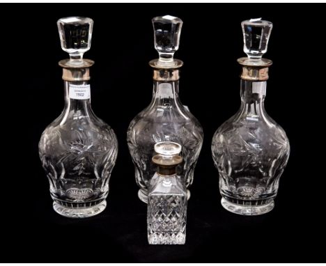 Three silver collared cut glass decanters, comprising two Birmingham 1992, and one Birmingham 1991, with a cut glass silver c