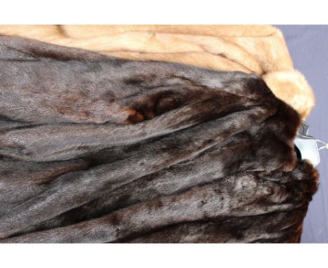 A long light brown mink coat with scalloped hem, hook and eye fastening, together with a dark brown mink jacket (2)