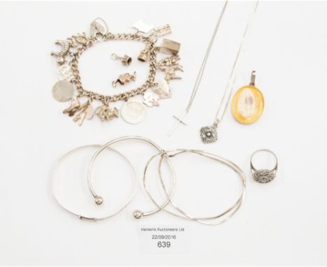 A collection of silver jewellery to include charm bracelet, torque bangle, bangle, chains, marcasite ring, pendant charms etc