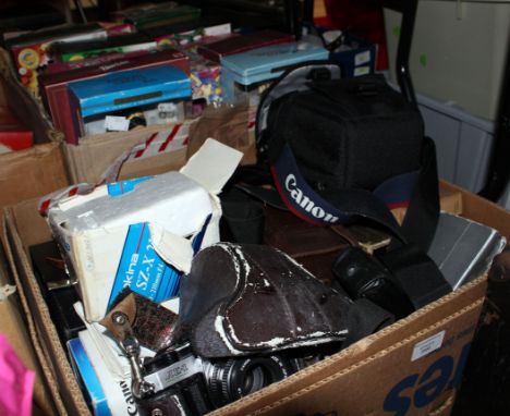 A box containing a collection of assorted cameras and lenses, including Pentax Tokina lens, Canon Jessop 58 mm lens, Cannon c
