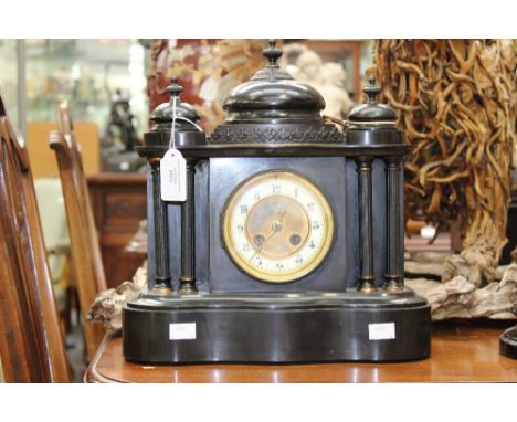 A 19th Century black slate, eight day mantel clock with a white enamelled chapter dial and Arabic numerals