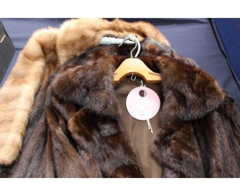 A dark brown 3/4 length mink coat with a double pointed lapel collar, lining in fair condition, some repairs needed in places