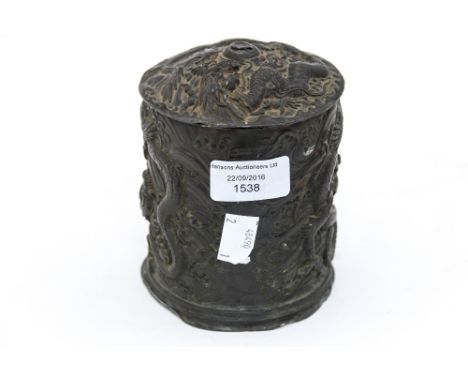A Chinese tobacco jar and cover in lead and copper, having heavy embossed dragons racing around the outside (damaged finial)