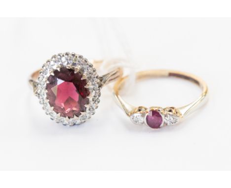 A garnet and diamond 18 ct gold cluster ring, the central garnet approx. 10 x 7 mm with diamond chip surround, gross weight 4