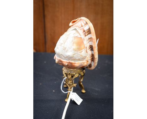 A carved shell table lamp, decorated with a classical maiden