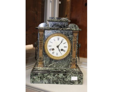 A 19th Century green and black marble mantle clock, with a white enamel dial, Roman numerals, twin winding holes, movement nu