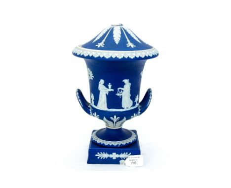 A Wedgwood Jasperware twin handled urn on plinth, with cover, finial to cover is missing