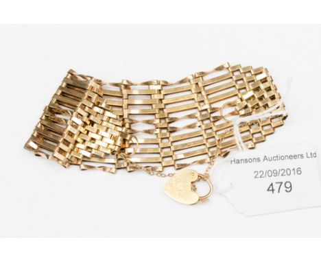 A 9 ct gold graduated gate bracelet of ten bars to the centre, with padlock clasp, approx. 18 grms 