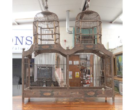 A decorative painted wood and metal bird cage of architectural form