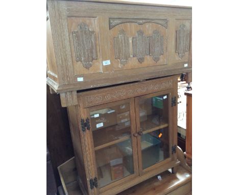 A limed oak bookcase, fitted with two glazed doors opening to reveal a single shelf, together with a small limed oak coffer w