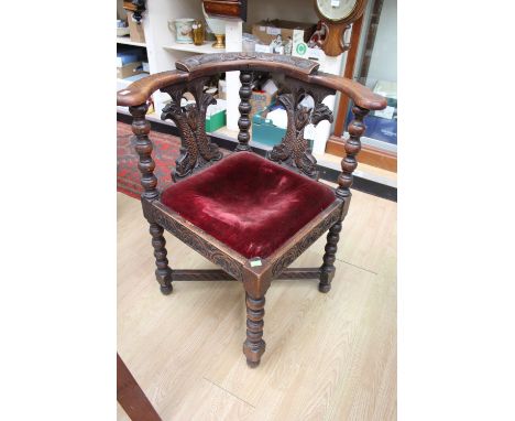 A mid Victorian carved oak corner chair, the back carved with initials 'TB', standing on bobbin turned legs