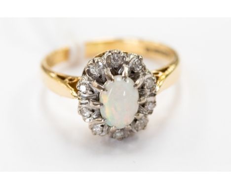 An 18 ct. gold opal and diamond cluster ring, size M 1/2