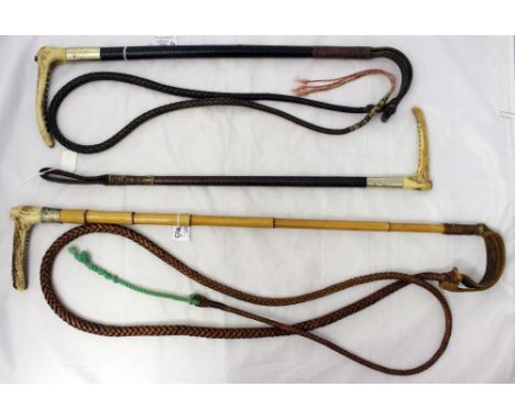 Two white metal collared and antler handled hunting crops with thongs, together with a similar crop (3) 