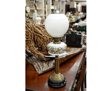 A mid 19th Century oil lamp, brass furrowed stand/black glass, milk glass hand painted well with globe and funnel