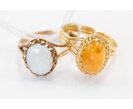 A 9 ct. gold opal ring, size M, and an amber stone ring (2)