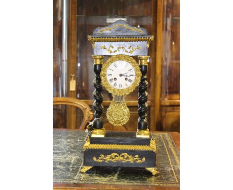 A Louis XVI style mantel clock, circa 1890, ebonised case with barley twist column, mounted in gilt metal with decorative pen