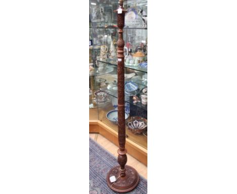 A large ornately carved standard lamp, the column carved throughout with foliage decoration, 160 cm high approx. 