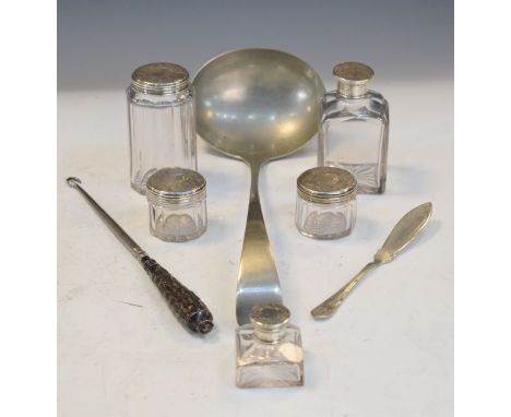 Silver handled button hook, four glass requisites each having an engraved silver cover, silver plated ladle etc   Condition: 