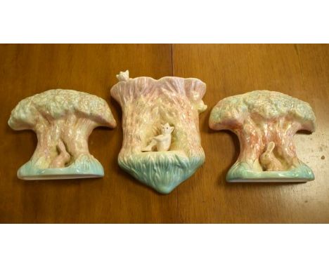 Pair of Sylvac wall vases, each decorated with a bunny seated beneath a tree together with a similar wall pocket decorated wi