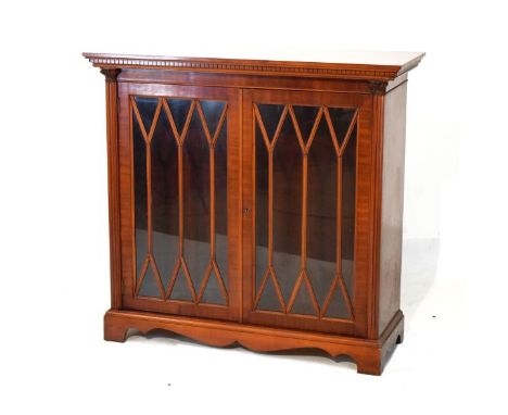 Reproduction mahogany cabinet bookcase fitted three shelves enclosed by a pair of astragal glazed doors and standing on brack